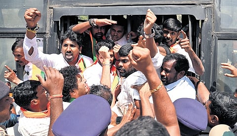 Police detain BJP workers during their protest condemning Youth Congress workers staging a shirtless dharna at the India-AI Impact Summit in New Delhi, at Freedom Park in Bengaluru on Saturday
