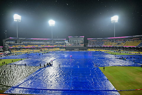 Ground staff cover the field as rain delayed the start of the 2026 ICC Men's T20 Cricket World Cup Super Eight match between Pakistan and New Zealand at the R Premadasa Stadium in Colombo.