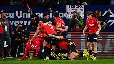 Osasuna's Raul Garcia celebrates with his teammates after scoring his side's second goal during a Spanish La Liga soccer match between Osasuna and Real Madrid in Pamplona, Spain, Saturday, Feb. 21, 2026.