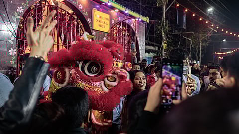 Revellers enjoying during the traditional dragon dance on the occasion of Chinese New Year at Tiretta Bazaar, Kolkata