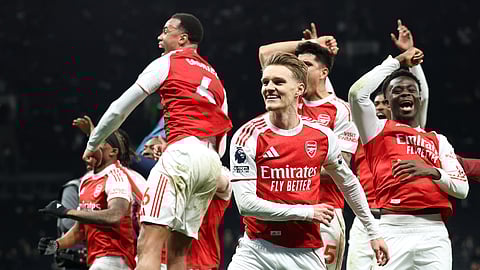 Arsenal players celebrate winning the English Premier League soccer match between Tottenham Hotspur and Arsenal in London, Sunday, Feb. 22, 2026.