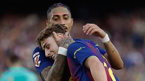 Barcelona's Raphinha hugs Fermin Lopez after a goal during a La Liga soccer match between Barcelona and Levante in Barcelona, Spain, Sunday, Feb. 22, 2026.