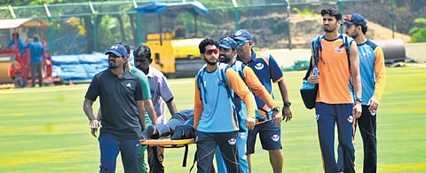 Jammu & Kashmir team members carry a player, who collapsed while inspecting the KSCA Stadium in Hubballi on Monday