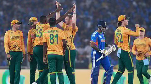 South Africa's players celebrate the wicket of India's captain Suryakumar Yadav, third right, during the T20 World Cup cricket match between India and South Africa in Ahmedabad, India, Sunday, Feb. 22, 2026. (AP Photo/Ajit Solanki)