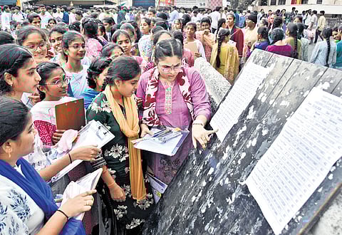 Intermediate students check their hall ticket numbers at an examination centre in Vijayawada on Monday.