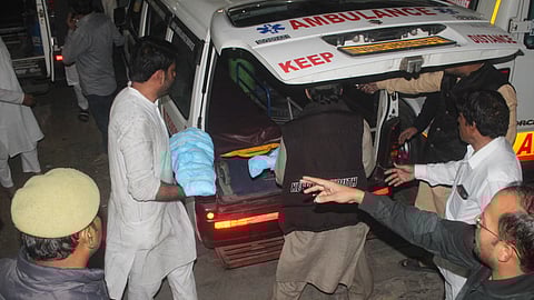 People carry victims to an ambulance after a fire broke out at a house, in Meerut, Uttar Pradesh, Monday, Feb. 23, 2026.