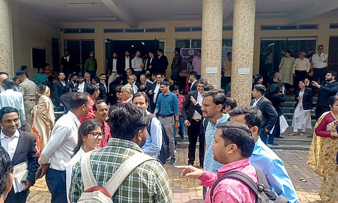 People gather outside the Asansol District Court after it received a bomb threat email.