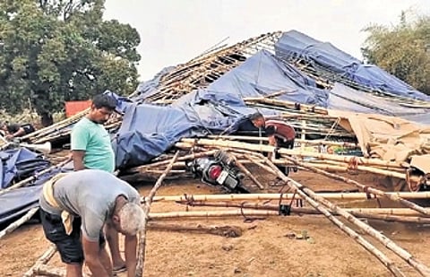The two workers were standing near the stage when the tent collapsed on them.