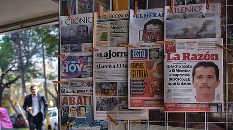 Newspapers hang on display for sale in Mexico City, Monday, Feb. 23, 2026, a day after the Mexican army killed Jalisco New Generation Cartel leader Nemesio Oseguera Cervantes, known as "El Mencho."