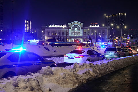 Police and emergency services are seen at the scene of an attack on a police patrol near the Savyolovsky Railway Station, in Moscow, Tuesday, Feb. 24, 2026.