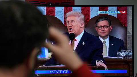 A man holds his head as he watches US President Donald Trump deliver the State of the Union address from Rep. Zach Nunn campaign office, Tuesday, Feb. 24, 2026, in West Des Moines, Iowa.