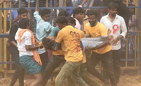 An injured tamer being carried away at the jallikattu organised by Khajamalai Jallikattu Peravai at Jamal Mohamed college ground on Wednesday