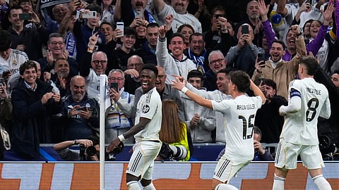 Real Madrid's Vinicius Junior, left, celebrates with teammates after scoring his side's second goal during the second leg of the Champions League playoff soccer match between Real Madrid and Benfica in Madrid, Spain, Wednesday, Feb. 25, 2026.