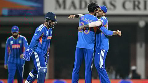 India's captain Suryakumar Yadav (R) congratulates teammate Axar Patel (2R) after the wicket of Zimbabwe's Tadiwanashe Marumani during the 2026 ICC Men's T20 Cricket World Cup Super Eights match between India and Zimbabwe at the MA Chidambaram Stadium in Chennai.