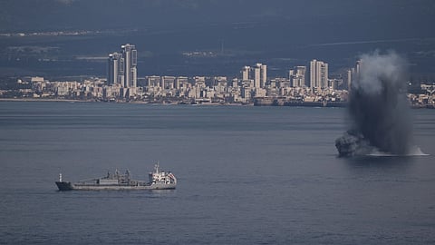 An incoming projectile explodes over the water as Israel issues a nationwide alert following its strikes on Iran, in Haifa Bay, northern Israel, Saturday, Feb. 28, 2026.