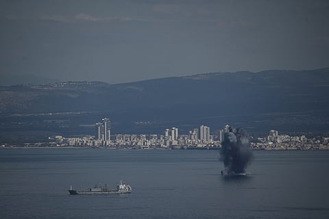 An incoming projectile explodes over the water as Israel issues a nationwide alert following its strikes on Iran, in Haifa Bay, northern Israel, Saturday, Feb. 28, 2026.