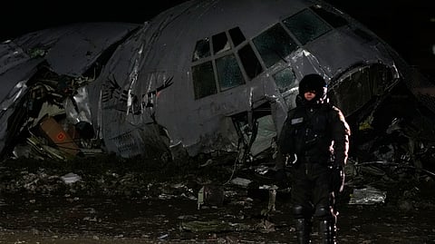 A military police stands next to a plane that crashed in El Alto, Bolivia, Friday, Feb. 27, 2026.