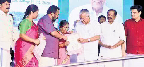 Vellarmala native Madhavi breaks down while receiving the title deed from Chief Minister Pinarayi Vijayan at the Kalpetta Township Project inauguration in Wayanad