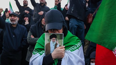 People mourn the killing of Iranian Supreme Leader Ayatollah Ali Khamenei at a square in Tehran on Sunday.