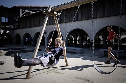An 84-year-old Alzheimer's patient enjoys a swing in the village Landais Alzheimer site for Alzheimer's patients in Dax, southwestern France