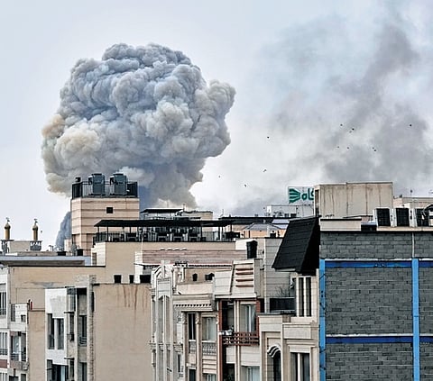 A plume of smoke rises after a strike in Tehran, Iran, as a
result of the ongoing tensions, on Monday.