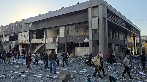 People gather at the site of an Israeli airstrike that targeted the offices of Al-Qard al-Hassan, a Hezbollah-linked financial institution, in the southern coastal Lebanese city of Tyre on March 2, 2026.