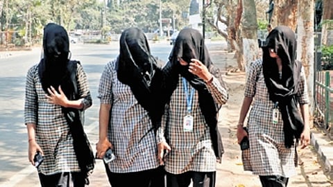 College girls cover themselves with dupattas to escape the heat