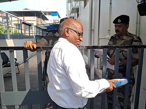 N Vasu showed his documents to CISF officials at the ED office in Kochi before entering the premises.