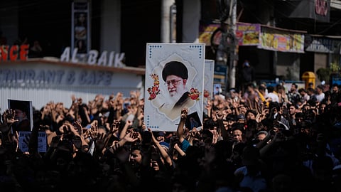 Shiite Muslims hold a photograph of Iran's Supreme Leader Ayatollah Ali Khamenei during a protest against the U.S. and Israel in Jammu, India, Sunday, March 1, 2026.