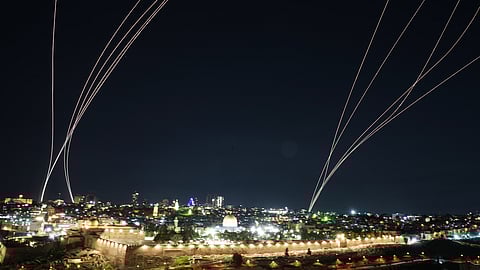 Israeli air defense system fires to intercept missiles launched from Iran toward Israel, over Jerusalem, Sunday, March 1, 2026.