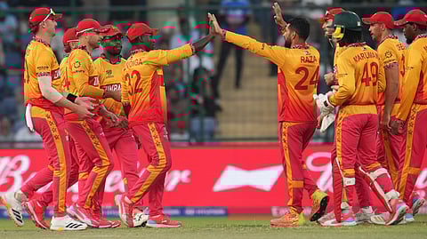 Zimbabwe's captain Sikandar Raza, centre, celebrates with teammates the wicket of South Africa's Dewald Brevis during the T20 World Cup cricket match between South Africa and Zimbabwe in New Delhi, India, Sunday, March 1, 2026.