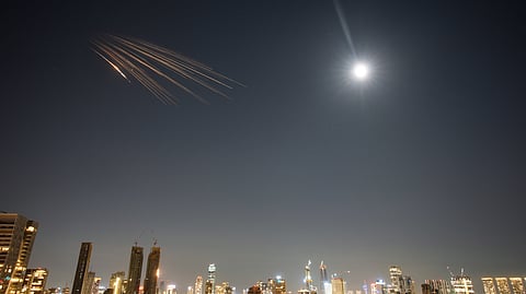 Missiles launched from Iran are seen in the sky over central Israel, Thursday, March 5, 2026.