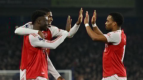 Arsenal's English midfielder Bukayo Saka (L) celebrates with teammates after scoring the opening goal of the EPL football match between Brighton and Hove Albion and Arsenal at the American Express Community Stadium in Brighton, southern England on March 4, 2026.