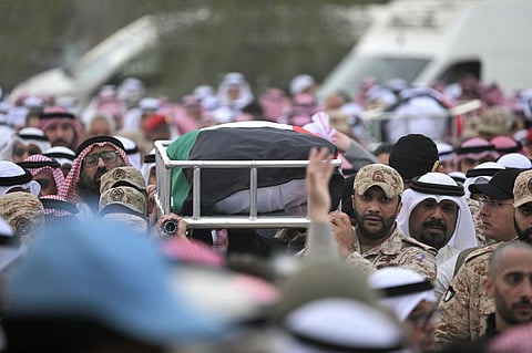 Mourners carry the flag draped body of a Kuwait Army members who were killed in an Iranian strike on Kuwait at the Sulaibikhat cemetery, west of Kuwait City on March 3, 2026.