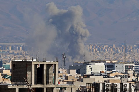 Smoke rises from the site of airstrikes in a central area of the Iranian capital Tehran.
