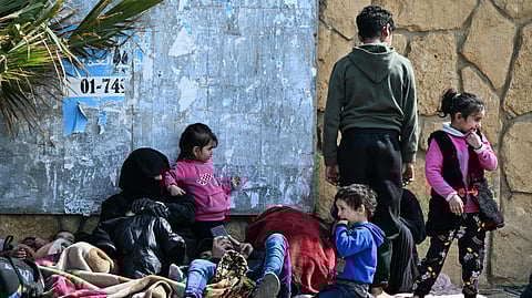 Displaced residents who fled Israeli airstrikes in Beirut's southern suburbs sit along the corniche waterfront in the Lebanese capital on March 6, 2026.