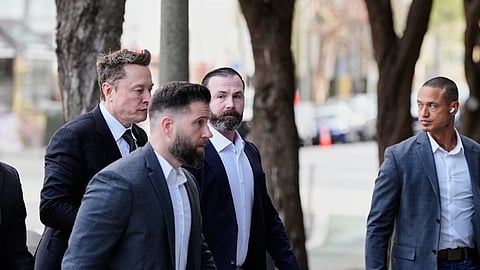 Elon Musk, left, arrives for a Twitter shareholder trial at the U.S. District Court for the Northern District of California, Wednesday, March 4, 2026, in San Francisco.