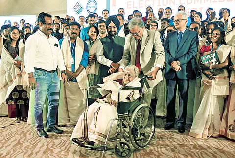Chief Election Commissioner Gyanesh Kumar honouring 96-year-old P V Vishalam at a meeting held by the Election Commission in Kochi.