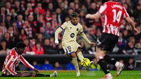 Barcelona's Lamine Yamal, center, scores his side's opening goal during the Spanish La Liga soccer match between Athletic Bilbao and Barcelona in Bilbao, Spain, Saturday, March 7, 2026.