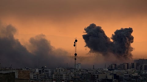 A plume of smoke rises following a U.S.-Israeli military strike in Tehran, Iran, Tuesday, March 3, 2026.