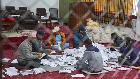 Election official count votes at a counting center for parliamentary election in Lalitpur, Nepal, Sunday, March 8, 2026.