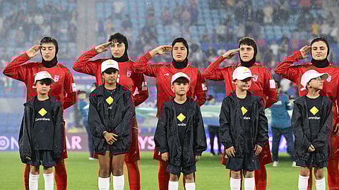 Iran players react during their national anthem ahead of the Women's Asian Cup soccer match between Iran and the Philippines in Robina, Australia, Sunday, March 8, 2026.