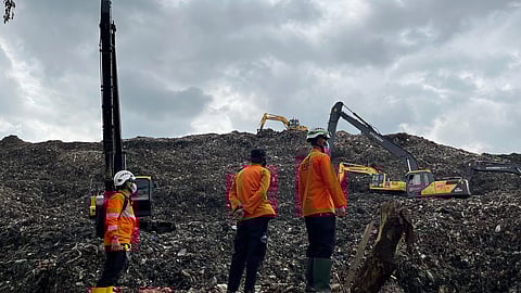 In this photo released by the Indonesian National Search and Rescue Agency (BASARNAS) on Monday, March 9, 2026, rescuers inspect the site of an avalanche of garbage that killed multiple people as heavy machines are used to search for victims at a landfill in Bantargebang, West Java, Indonesia.