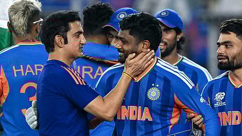 India's Sanju Samson (C) celebrates with his coach Gautam Gambhir (L) after their team's win in the 2026 ICC Men's T20 Cricket World Cup final match against New Zealand at the Narendra Modi Stadium in Ahmedabad on March 8, 2026.