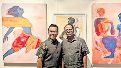 Ramli Ibrahim poses with curator Ramahari Jena in front of the former’s artwork at the exhibition