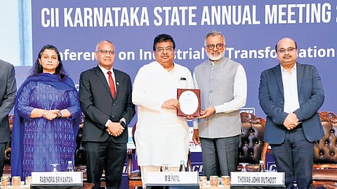 Minister for Large and Medium Industries MB Patil with other dignitaries at the annual meeting of the state unit of the Confederation of Indian Industry.