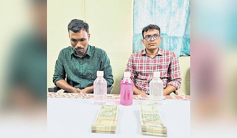 The accused officers, Pramod Goud and Jatavath Babu Naik of the LB Nagar Cyber Crime police station.