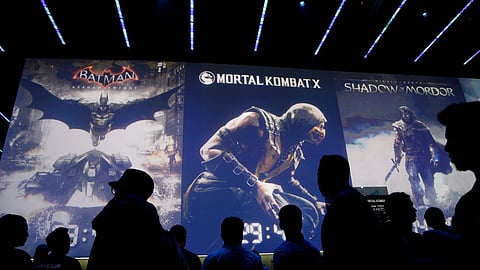 People wait in line for theater presentations for video games including Batman, Mortal Kombat X and Shadow of Mordor at the WB Games booth at the Electronic Entertainment Expo, Wednesday, June 11, 2014, in Los Angeles.