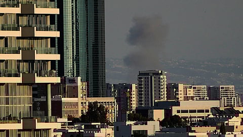 Smoke billows following an Iranian missile attack in central Israel, Monday, March 9, 2026.