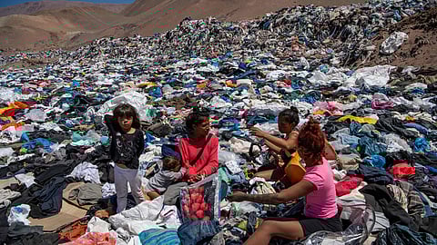 Women search for used clothes amid tonnes discarded in the Atacama desert, Chile